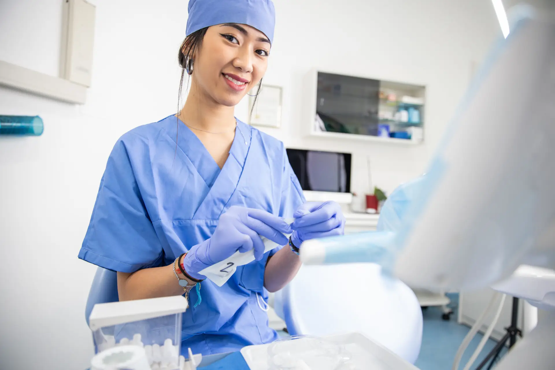 Female dentist preparing tools in clinic