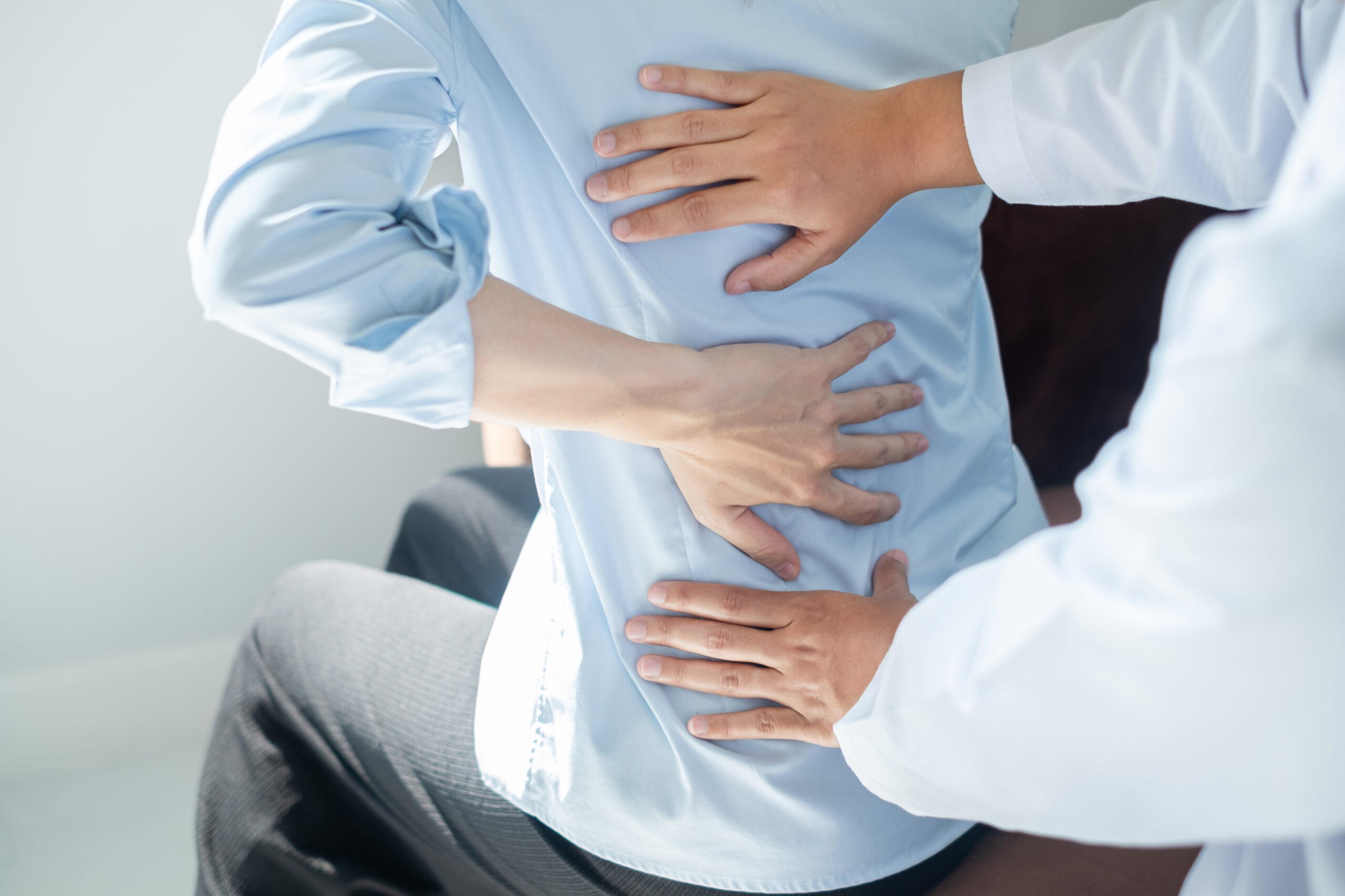 Physiotherapist assisting with back