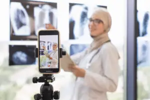 Doctor recording medical lesson with X-ray